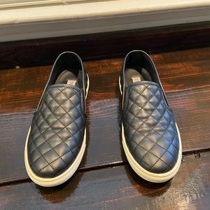 Black quilted slip on sneakers